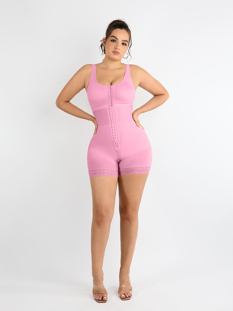 Woman wearing pink full-body shapewear with front hook closure and lace-trimmed shorts